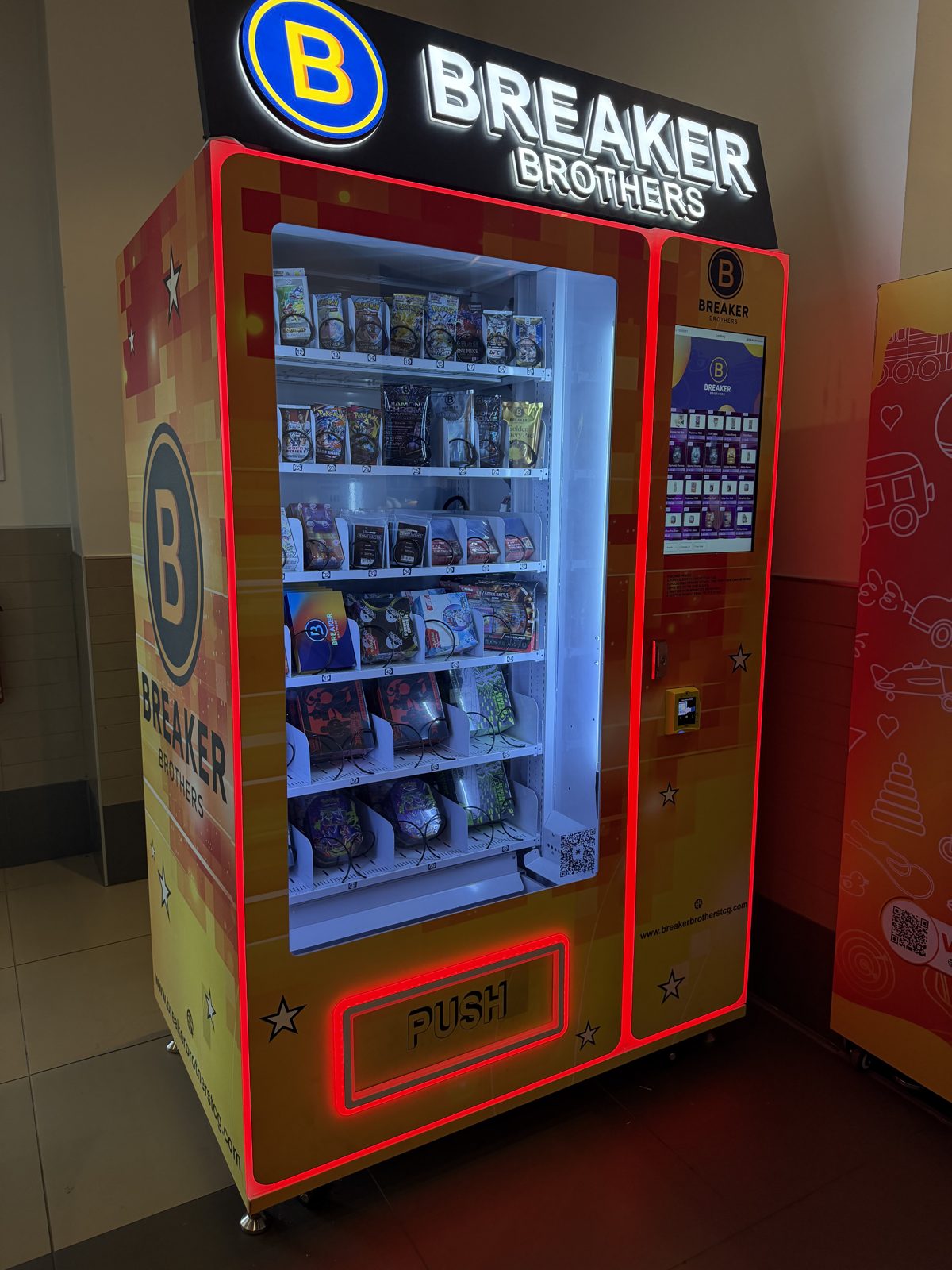 Custom branded Breaker Brothers trading card vending machine with LED lighting in a mall